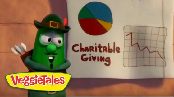 Green VeggieTales character in a hat points to a page titled 'Charitable Giving' showing a multicolored pie chart and a downward line graph; VeggieTales logo bottom left.