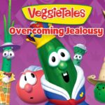 VeggieTales cover with a crown-wearing cucumber center stage among veggie friends, purple background and 'Overcoming Jealousy' title.