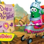VeggieTales scene: a knightly cucumber and friends ride a wooden war cart beneath a purple banner reading 'Duke and the Great Pie War'
