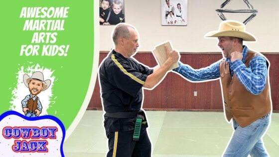 Playful thumbnail showing a martial arts instructor in black gi and a cowboy in a hat sparring with a wooden board in a kids' martial arts video thumbnail.