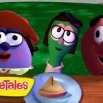 Three VeggieTales characters lean over a wooden table to look at a small pie on a plate, VeggieTales logo in the corner.