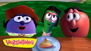 Three VeggieTales characters lean over a wooden table to look at a small pie on a plate, VeggieTales logo in the corner.