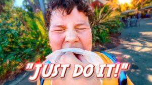 Person with eyes squeezed shut, biting a tissue in their mouth outdoors, with bold 'JUST DO IT!' text across the bottom.