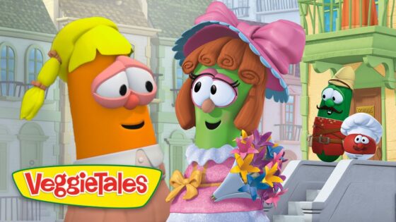 Two VeggieTales characters converse on a sunny cartoon street; a green veggie in a pink dress and hat holds a colorful bouquet while an orange carrot listens. VeggieTales logo on the corner.