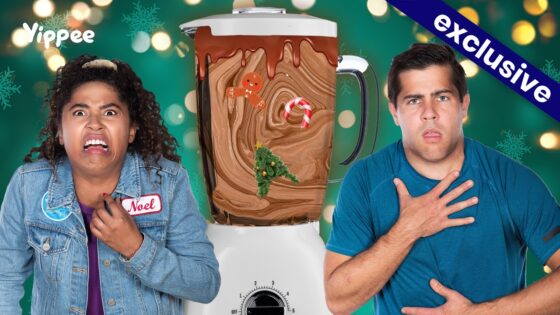 Two people look shocked beside a blender filled with chocolate swirl and holiday decorations (gingerbread, candy cane, Christmas tree) against a festive green background with an 'exclusive' banner.