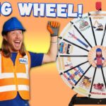 Man in a blue hard hat and orange safety vest cheers next to a large song wheel on an orange background, for a kids' video thumbnail.
