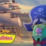 VeggieTales logo in the foreground with a green pirate character wearing a blue tricorn hat and yellow glasses, sailing beside a large pirate ship on a rocky sea.
