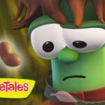 Green veggie character with brown hair and a puzzled expression in a forest, VeggieTales logo in the corner