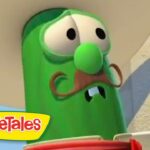 Larry the Cucumber from VeggieTales with a brown mustache and googly eyes.