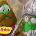 Two VeggieTales characters, a brown-hatted veggie and a green veggie in a helmet and goggles, share a smile; VeggieTales logo sits in the corner.