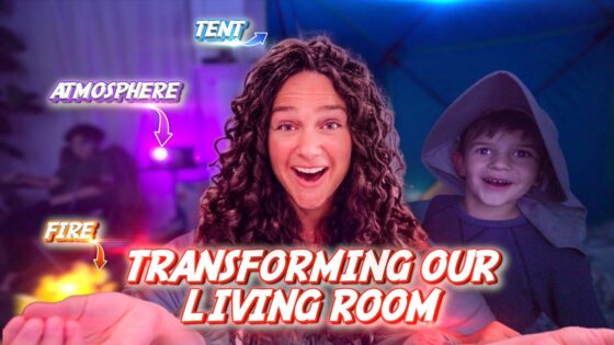 Smiling woman with curly hair in a living room, a child in a hooded cloak, with bold red text 'Transforming Our Living Room' and purple lighting effects.