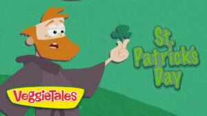VeggieTales character with an orange beard holding up a shamrock beside the text 'St. Patrick's Day' on a green background.
