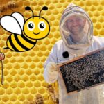 Beekeeper in protective suit holding a honeycomb frame, with a cartoon bee and jar of honey over a honeycomb background.