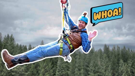 Man ziplining over a forest, wearing a blue helmet, brown vest and safety harness, with a 'WHOA!' cartoon bubble beside him.