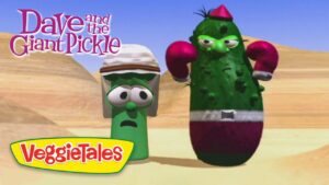 Title screen from VeggieTales: Dave and the Giant Pickle, showing two anthropomorphic cucumbers boxing in a desert, with the 'Dave and the Giant Pickle' and 'VeggieTales' logos.