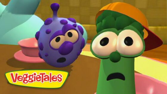 Green vegetable with an orange cap and wide-eyed, surprised expression beside a purple speckled veggie in a colorful VeggieTales set (logo bottom left).