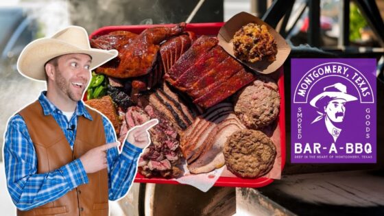 Man in a cowboy hat and blue plaid shirt points excitedly at a red tray of smoked meats (ribs, brisket, turkey) in a BBQ setup with a purple Bar-A-BBQ sign from Montgomery, Texas.