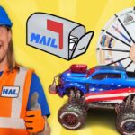 Smiling man in a blue hard hat and orange safety vest beside a red-white-blue toy truck and a prize wheel.