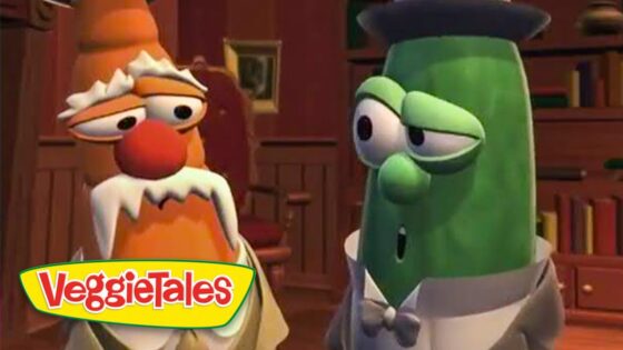 Two VeggieTales characters, an orange carrot and a green cucumber, in a wood-paneled room wearing formal clothes and talking together.