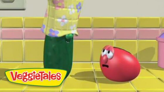 From VeggieTales: a green vegetable in a yellow floral shirt looms over a red, worried tomato on a yellow tiled floor.
