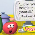 VeggieTales cucumber and tomato look at a computer screen displaying 'Love your neighbor as yourself' (Lev. 19:18).