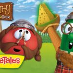 VeggieTales thumbnail: a red veggie with a mustache and helmet next to a green veggie wearing glasses, holding a cheese wedge on a stick in a sunny field, with 'MacTarry & The Stinky Cheese Battle' title.