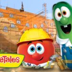 Tomato and cucumber VeggieTales characters in hard hats stand beside a ship under construction with scaffolding, logo visible on the bottom left.