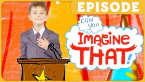 Boy in a gray suit stands at a wooden podium with a microphone, smiling, against an orange background; a large cartoon speech bubble reads 'Imagine That!' with an 'EPISODE' banner above.