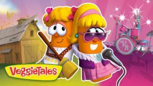 VeggieTales cartoon vegetables performing on a stage with a microphone and a drummer in the pink background.