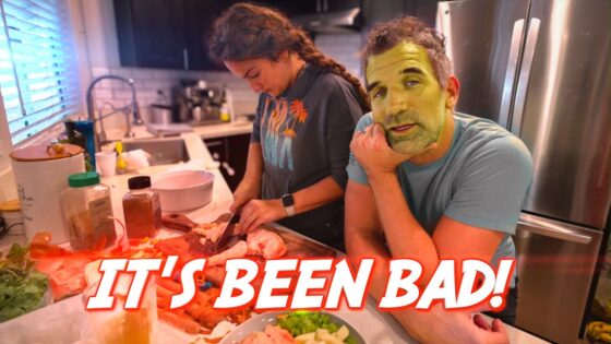 Two people cook in a bright kitchen with chopped chicken on the counter; one man has green makeup on his face, and a bold 'IT'S BEEN BAD!' caption is overlaid across the image.