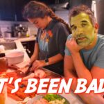 Two people cooking in a home kitchen; one chops on a cutting board while the other rests his chin on his hand, with a bold 'IT'S BEEN BAD!' caption across the scene.