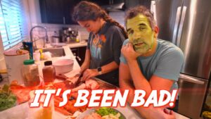 Two people cooking in a home kitchen; one chops on a cutting board while the other rests his chin on his hand, with a bold 'IT'S BEEN BAD!' caption across the scene.