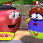 Two VeggieTales characters, a red tomato and a blue berry wearing a hat, chat in a sunny park with bikes in the background (VeggieTales logo foreground).