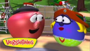 Two VeggieTales characters, a red tomato and a blue berry wearing a hat, chat in a sunny park with bikes in the background (VeggieTales logo foreground).