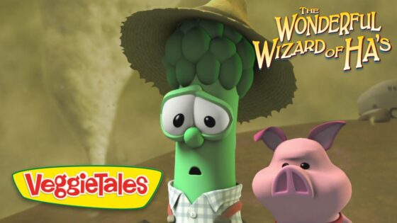 Animated VeggieTales scene: a green cucumber and a pink pig look surprised, wearing a hat, with 'The Wonderful Wizard of Ha's' logo in the corner.