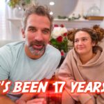 Couple sits on a beige sofa, smiling at the camera, with a bold red caption reading 'IT'S BEEN 17 YEARS...' overlay.