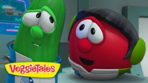 Two VeggieTales characters—a green cucumber and a red tomato—talk in a futuristic spaceship cockpit with the VeggieTales logo visible.