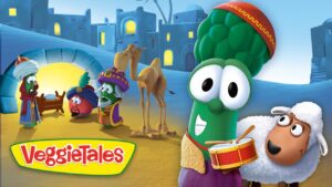 Animated VeggieTales scene with a green broccoli drummer and a sheep on a sandy town square, bright colors in the background.