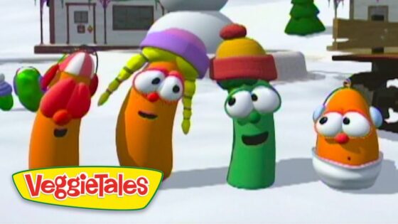 Three colorful VeggieTales characters stand on snow, smiling and chatting in a wintry scene with a logo in the corner.