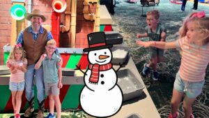 Man in a cowboy hat pose with three children at a colorful indoor play area; cartoon snowman overlays the foreground.