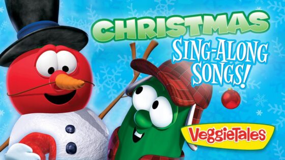 Cartoon red snowman with a blue hat and carrot nose posing with a green veggie wearing a plaid hat; 'Christmas Sing-Along Songs!' VeggieTales background
