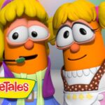 Two orange VeggieTales characters with blonde hair pose closely, wearing colorful costumes and smiling; VeggieTales logo visible on the corner.