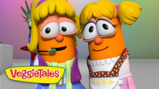 Two orange VeggieTales characters with blonde hair pose closely, wearing colorful costumes and smiling; VeggieTales logo visible on the corner.