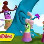 Colorful VeggieTales characters stand on a grassy hill beside a blue spiraled tree under a bright sky with a sun on the left.