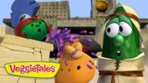 VeggieTales characters in an ancient temple as purple slime splashes onto an orange veggie, with two surprised lookers nearby.