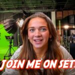 Woman on a film/TV set with a green screen, lights and cameras visible; bold caption 'JOIN ME ON SET!' across the bottom.