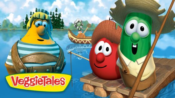 Three VeggieTales characters—a yellow veggie, a red tomato, and a green cucumber—stand on a wooden raft on a lake with a small guitarist boat in the background; trees and sky visible behind.