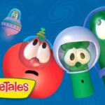 Red tomato and green cucumber wearing space helmets float in a blue background with the VeggieTales logo in the corner.