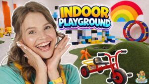 Cheerful woman in foreground with a colorful indoor playground and toy structures behind her.