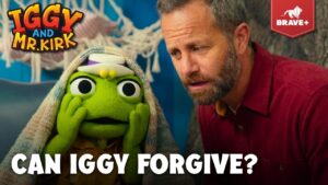 Thumbnail for Brave+ video: green puppet Iggy under a blanket beside a concerned man, caption 'CAN IGGY FORGIVE?'